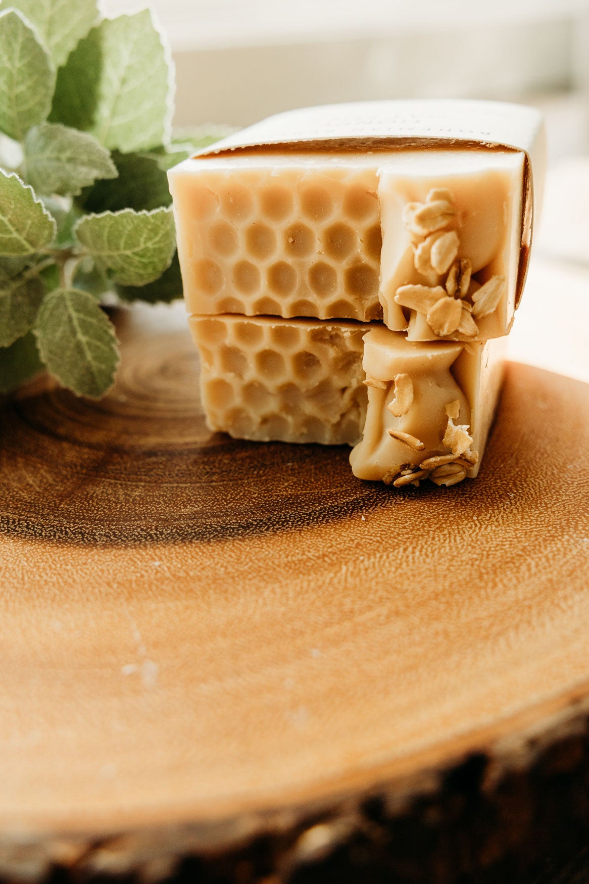 Bar of soap with honeycomb design on a wooden surface