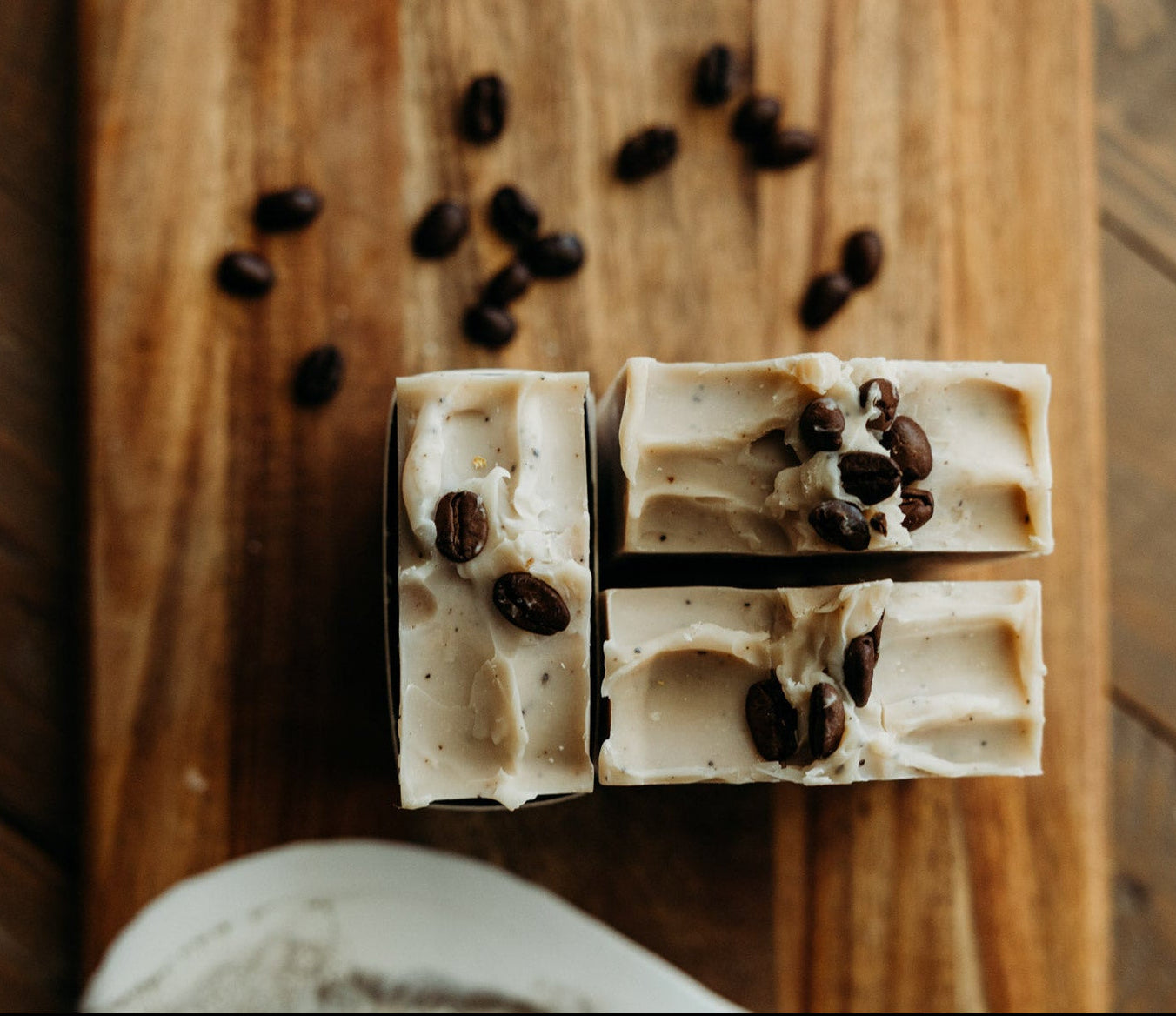 Bar of soap with coffee beans on a wooden cutting board
