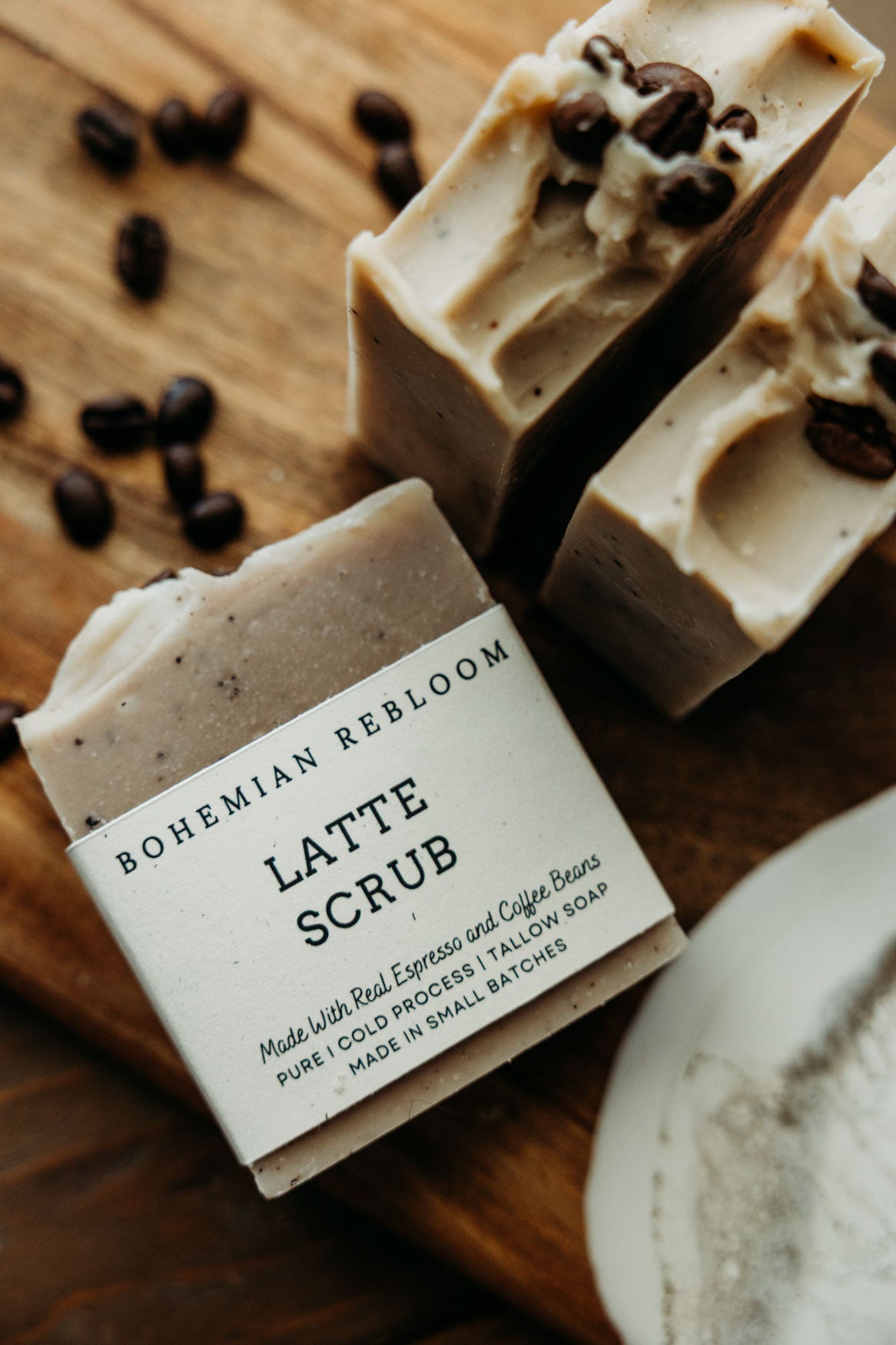Bohemian ReBloom Latte Scrub on a wooden surface with coffee beans