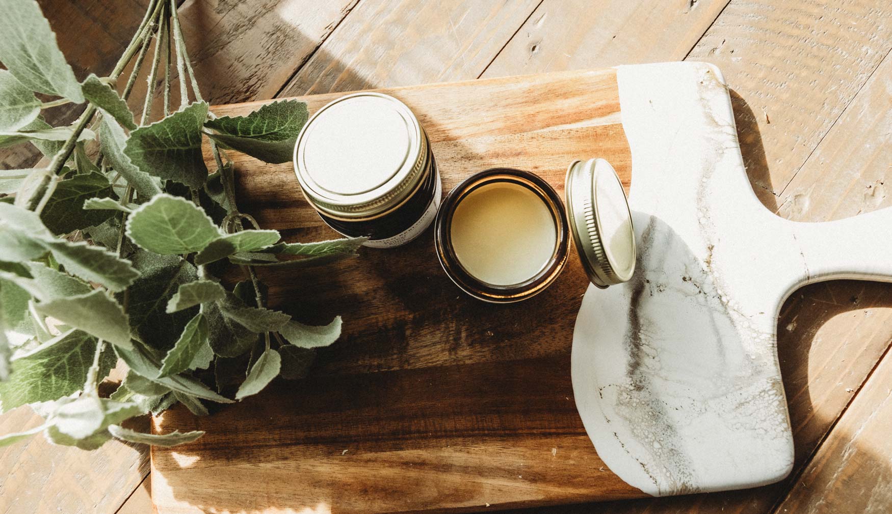 Two jars of Bohemian Rebloom Herbal Tallow Balm with one  jar open.  