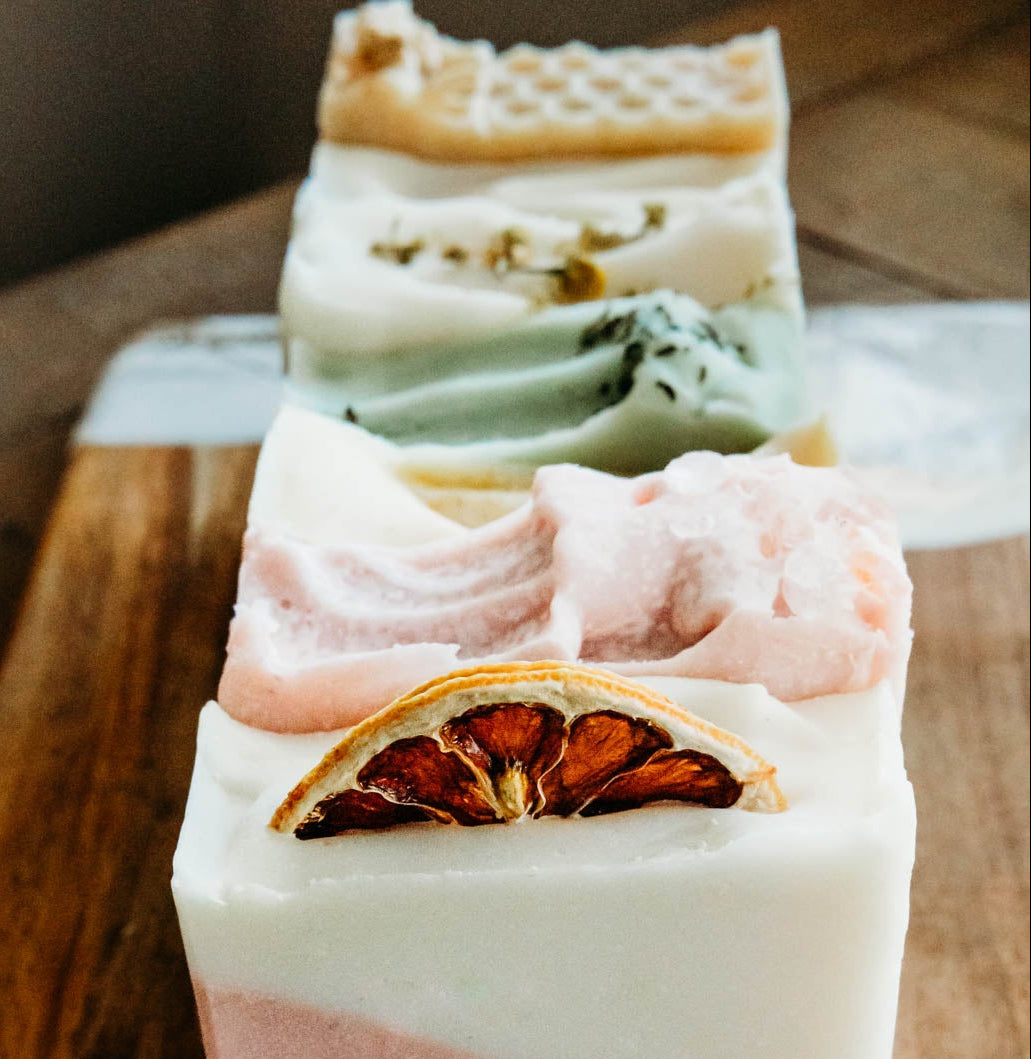 Three layered soap bars on a wooden surface