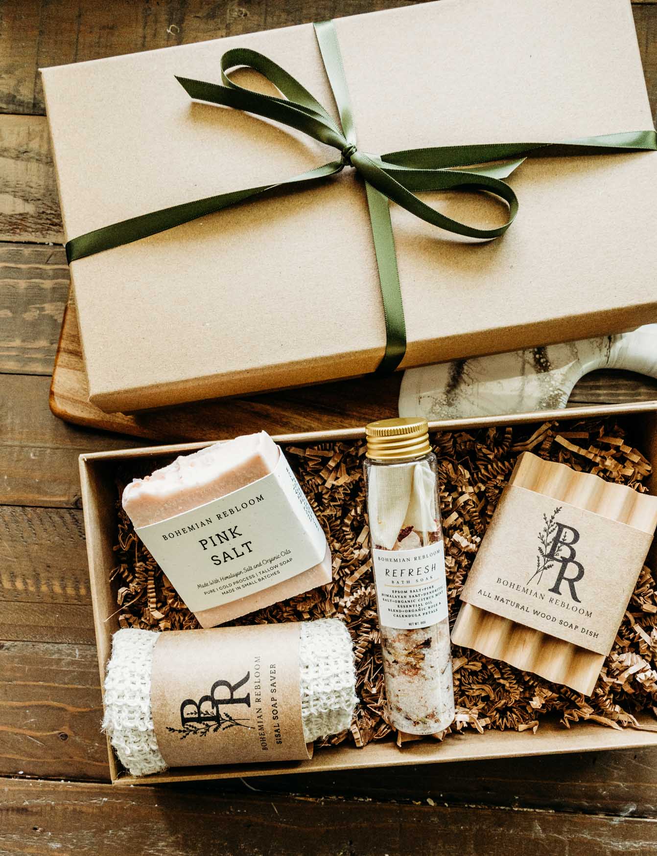 Spa gift set with a pink salt Himalayan soap bar, sisal soap saver bag, refresh bath salts, and wooden soap dish. 