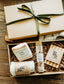 Spa gift set with a pink salt Himalayan soap bar, sisal soap saver bag, refresh bath salts, and wooden soap dish. 