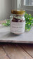 A glass mason jar with a gold lid with a label that has the Bohemian Rebloom brand name and states Hugs In A Jar - Positive Bible verses and scriptures. The back of the jar is then shown as well as the opening of one of the positive verse cardstock notecards inside the mason jar. 